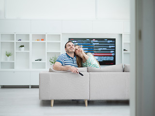 Image showing Young couple on the sofa watching television