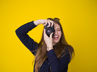 Image showing young girl taking photo on a retro camera