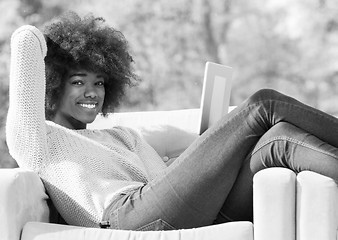 Image showing Beautifl black girl lying on couch