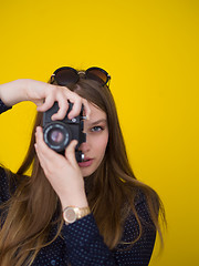 Image showing young girl taking photo on a retro camera