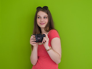 Image showing smilling girl taking photo on a retro camera