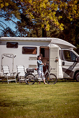 Image showing Woman on electric bike resting at the campsite