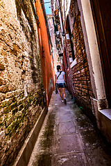 Image showing Woman walks through the narrow streets of Venice