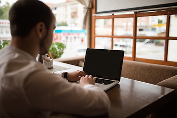 Image showing Man is looking at laptop with excitement.