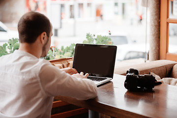 Image showing Man is looking at laptop with excitement.