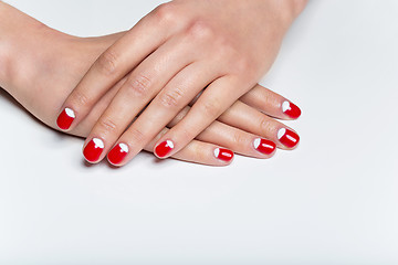 Image showing Female hands with red and white nails