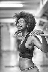 Image showing black woman lifting empty bar