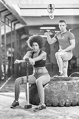 Image showing multiethnic couple after workout with hammer