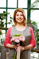 Image showing Young smiling girl in greenhouse