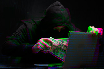 Image showing Thief in black with laptop,