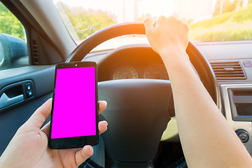 Image showing Woman holding smartphone in car