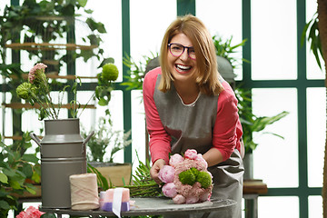 Image showing Girl with glasses makes bouquet