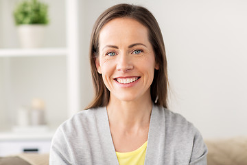 Image showing happy smiling middle aged woman at home