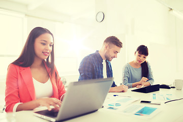 Image showing creative team with tablet pc and papers at office