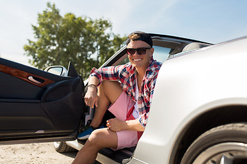 Image showing happy young man sitting in convertible car