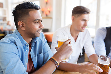 Image showing happy male friends drinking beer at bar or pub