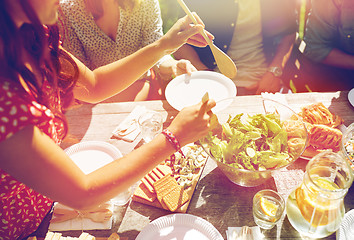 Image showing happy friends having dinner at summer party