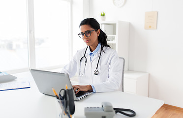 Image showing female doctor typing on laptop at hospital