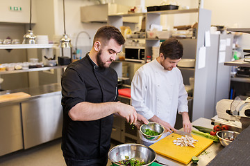 Image showing chef and cook cooking food at restaurant kitchen