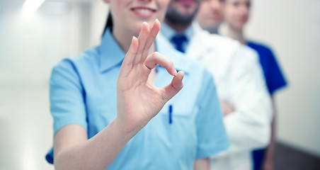 Image showing close up of doctors at hospital showing ok sign