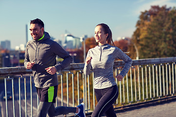 Image showing happy couple running outdoors