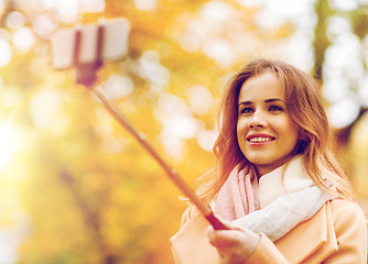Image showing woman taking selfie by smartphone in autumn park