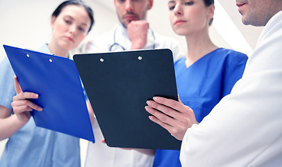 Image showing close up of doctors with clipboard at hospital