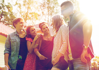 Image showing happy teenage friends hugging at summer garden