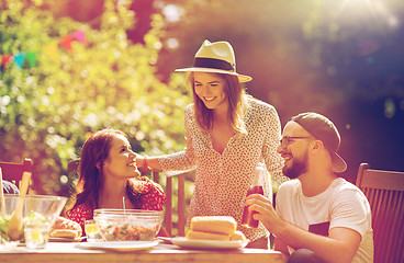 Image showing happy friends having dinner at summer garden party