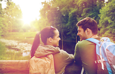 Image showing smiling couple with backpacks in nature