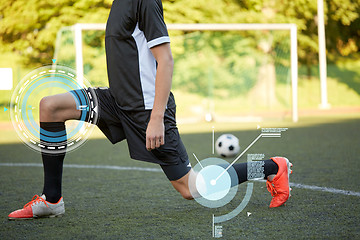 Image showing soccer player stretching leg on field football