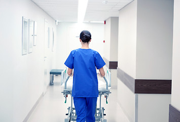 Image showing nurse carrying hospital gurney to emergency room