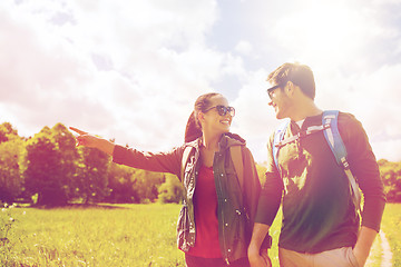 Image showing happy couple with backpacks hiking outdoors