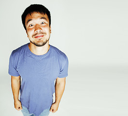 Image showing young cute asian man on white background gesturing emotional, po