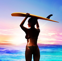 Image showing surfer with surfboard at sunrise