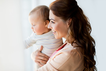 Image showing happy young mother with little baby at home