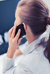 Image showing businesswoman with smartphone in office