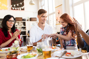 Image showing happy man doing proposal to woman at restaurant