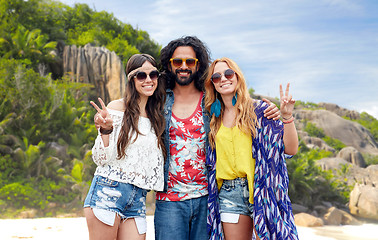 Image showing happy hippie friends showing peace on island beach