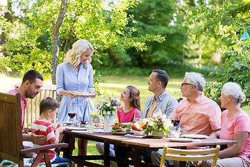 Image showing happy family having dinner or summer garden party