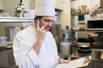 Image showing chef calling on smartphone at restaurant kitchen