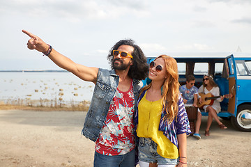 Image showing smiling young hippie friends near minivan car