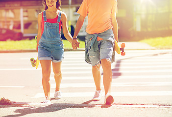 Image showing teenage couple with skateboards at city crosswalk