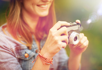 Image showing close up of woman with camera shooting outdoors