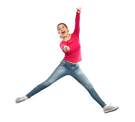 Image showing smiling young woman jumping in air