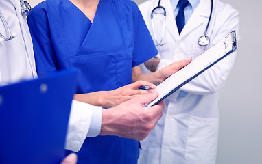 Image showing close up of doctors with clipboard at hospital