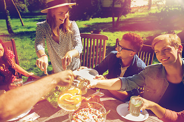 Image showing happy friends having dinner at summer garden party