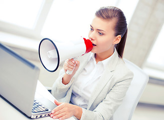 Image showing strict businesswoman shouting in megaphone