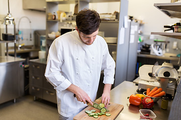 Image showing happy male chef cooking food at restaurant kitchen