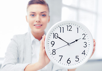 Image showing attractive businesswoman with white clock